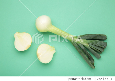 Green onion on mint background. Macro photo Green onion on mint background. Macro photo 128315584