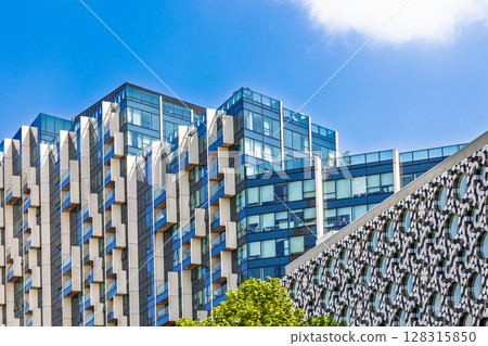 Contemporary glass apartment towers with geometric fins 128315850