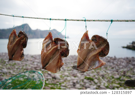 Dried Fish Hanging on Rope by the Sea in Korean Coastal Village Dried Fish Hanging on Rope by the Sea in Korean Coastal Village 128315897