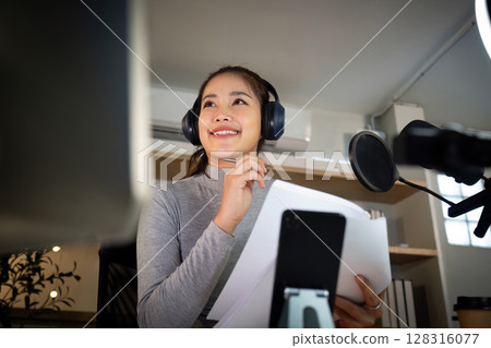 Podcast host enjoying a moment of inspiration during recording 128316077