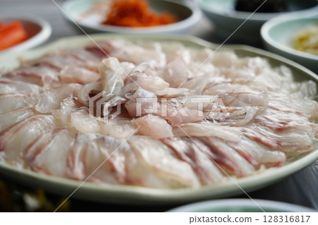 Freshly Sliced Korean Sashimi Platter. Raw Fish Served on a Plate 128316817