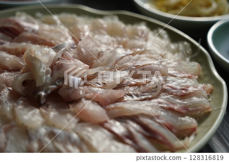 Freshly Sliced Korean Sashimi Platter. Raw Fish Served on a Plate Freshly Sliced Korean Sashimi Platter. Raw Fish Served on a Plate 128316819