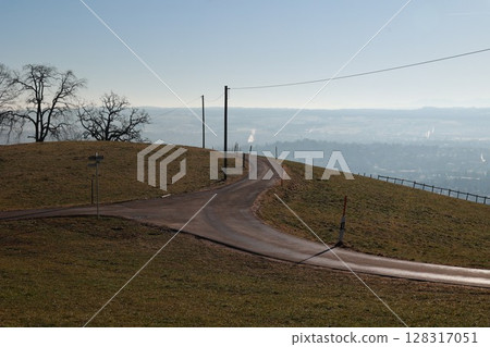 Road with a sign that says "No U-turns" and a telephone pole in the background Road with a sign that says "No U-turns" and a telephone pole in the background 128317051