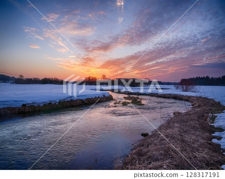 A river with a beautiful sunset in the background 128317191
