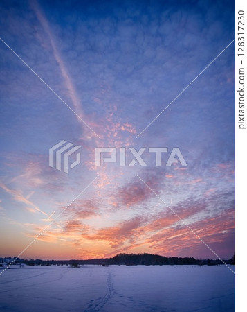 A beautiful sunset over a snowy landscape 128317230
