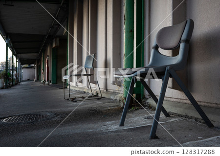 Chairs placed on the outdoor walkway of a building Chairs placed on the outdoor walkway of a building 128317288