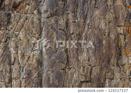 Rugged detailed sedimentary rock formation in mountainous Kyrgyzstan - texture and background 128317337