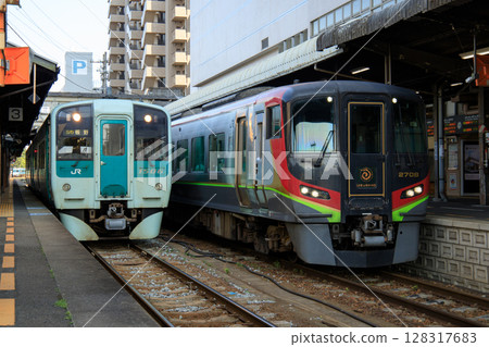 1500 series diesel railcars and 2700 series diesel railcars lined up at Tokushima Station (JR Shikoku) 128317683