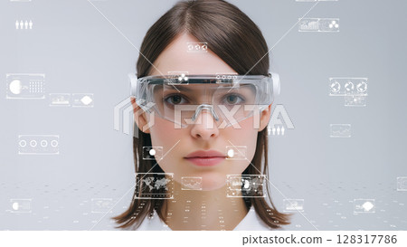 Digital science concept portrait, young woman wearing smart AR goggles and operating virtual diagnostics 128317786