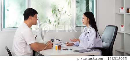Healthcare Consultation. Doctor discussing treatment options with male patient in modern clinic. Healthcare Consultation. Doctor discussing treatment options with male patient in modern clinic. 128318055