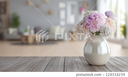 Fresh flowers in a vase on a wooden table with a cozy living room in the background during a bright afternoon Fresh flowers in a vase on a wooden table with a cozy living room in the background during a bright afternoon 128318239