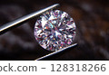 Close-up view of a brilliant round diamond being held by tweezers, showcasing its intricate facets and sparkling clarity 128318266