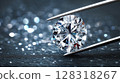 Close-up view of a brilliant cut diamond held by tweezers, showcasing its sparkling facets and clarity against bokeh background 128318267