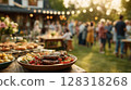 Outdoor summer gathering featuring a beautifully arranged platter of grilled meats and colorful vegetable 128318268