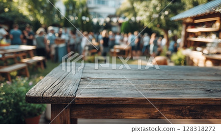 Rustic wooden table in vibrant outdoor setting, surrounded by lush greenery, blurred crowd enjoying a sunny day, creating a warm Rustic wooden table in vibrant outdoor setting, surrounded by lush greenery, blurred crowd enjoying a sunny day, creating a warm 128318272