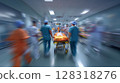 Medical team in scrubs swiftly transporting patient on stretcher through busy hospital corridor, showcasing urgency 128318276