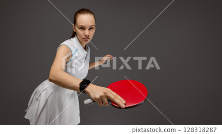 Focused table tennis player ready to hit the ball 128318287