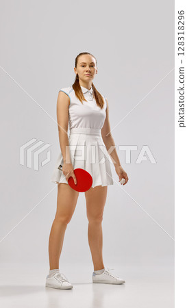 Young woman posing confidently with table tennis paddle Young woman posing confidently with table tennis paddle 128318296