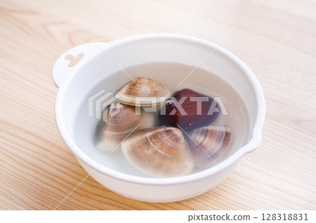 Clams being de-sanded Clams being de-sanded 128318831