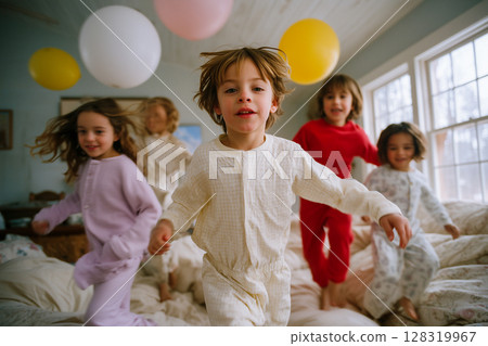 A group of children are playing with balloons in a bedroom 128319967
