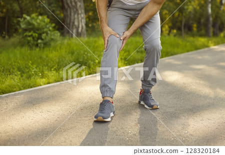 Sporty man holding knee in pain, after exercise, sports injury limiting activity, damage structures Sporty man holding knee in pain, after exercise, sports injury limiting activity, damage structures 128320184