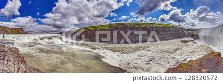 Panoramic view of Gullfoss waterfall Iceland with cliffs and green landscape Panoramic view of Gullfoss waterfall Iceland with cliffs and green landscape 128320572