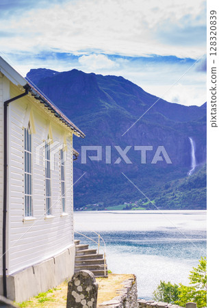 Wooden church in Nes village at fjord, Norway Wooden church in Nes village at fjord, Norway 128320839
