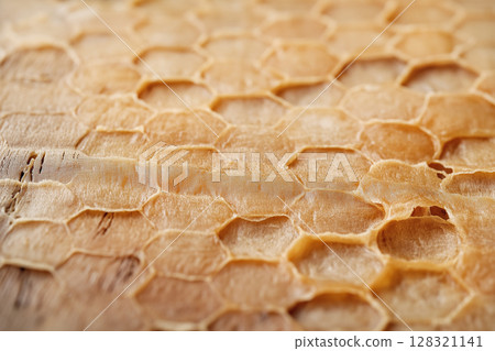 Honeycomb texture with hexagonal beeswax and natural pattern closeup showcasing organic honey. Honeycomb texture with hexagonal beeswax and natural pattern closeup showcasing organic honey. 128321141