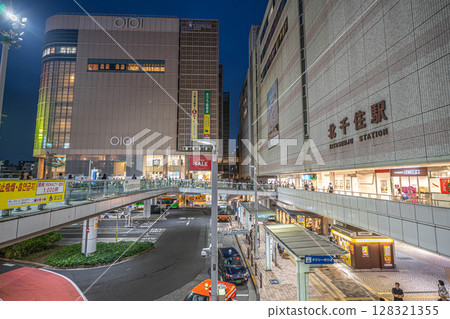 Night view of the west exit of Kitasenju Station, Marui, and the bus terminal in front of the station Night view of the west exit of Kitasenju Station, Marui, and the bus terminal in front of the station 128321355