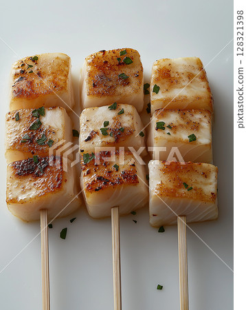 Grilled fish skewers with herbs and spices on a white background for culinary presentations 128321398