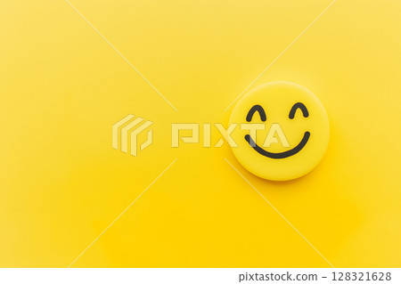 Emoji smile on yellow background: cheerful icon symbolizing joy and vibrant expression 128321628
