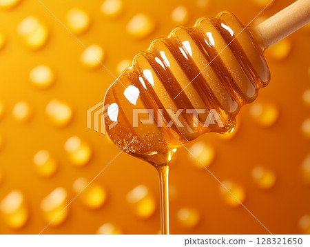 Honey dripping in a beautiful golden background with sweet natural organic syrup 128321650