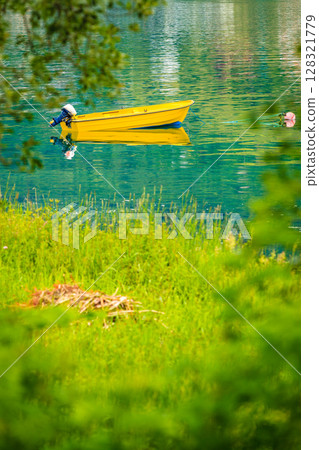 Little boat on water surface Little boat on water surface 128321779