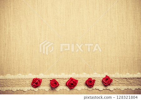 Frame of red silk roses on cloth 128321804