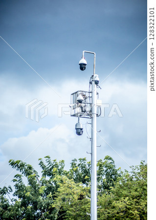 Top view of CCTV camera on top of a tall electric pole, focus selective// CCTV outd Top view of CCTV camera on top of a tall electric pole, focus selective// CCTV outd 128322101