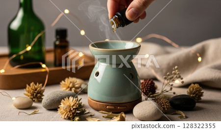 Hand Adding Essential Oil to Boho Diffuser Hand Adding Essential Oil to Boho Diffuser 128322355