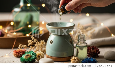 Hand Adding Essential Oil to Boho Diffuser Hand Adding Essential Oil to Boho Diffuser 128322364