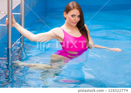 Woman having fun in swimming pool Woman having fun in swimming pool 128322774
