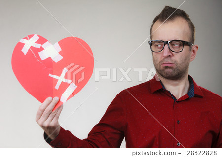 Sad adult man holding broken heart Sad adult man holding broken heart 128322828
