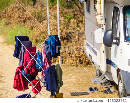 Clothes hanging to dry outdoors by camping car. Caravan vacation. Clothes hanging to dry outdoors by camping car. Caravan vacation. 128322881
