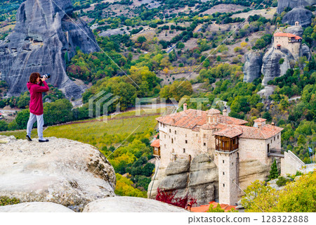 Woman take photo from Meteora monastery Woman take photo from Meteora monastery 128322888