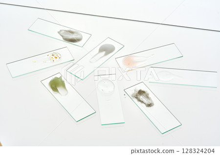Various cosmetic products on slides on a gray background. Various cosmetic products on slides on a gray background. 128324204