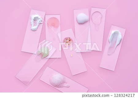Slides with various cosmetic products: creams and serums on a pink background. Slides with various cosmetic products: creams and serums on a pink background. 128324217