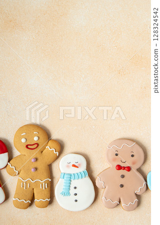 Gingerbread cookies with icing decoration. Christmas food. Gingerbread men and snowman. Top view table. Xmas sweet copy space background. Gingerbread cookies with icing decoration. Christmas food. Gingerbread men and snowman. Top view table. Xmas sweet copy space background. 128324542