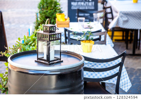 Lamp Outdoor empty Cafe seating Chairs and tables. 128324594