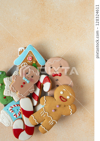 Gingerbread cookies with icing decoration. Christmas food. Gingerbread man baking. Top view table. Xmas sweet copy space background 128324611