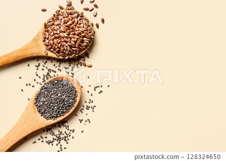 Flaxseeds and chia seeds on spoons 128324650