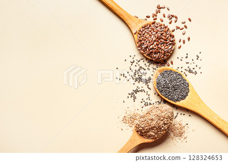 Flaxseeds, chia seeds and bran ground on spoons Flaxseeds, chia seeds and bran ground on spoons 128324653
