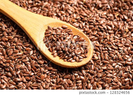 Linseed or flaxseed on wooden spoon 128324656