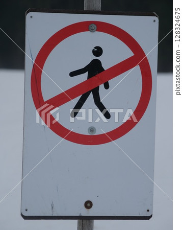 Sign with a red circle and a black man walking on it 128324675